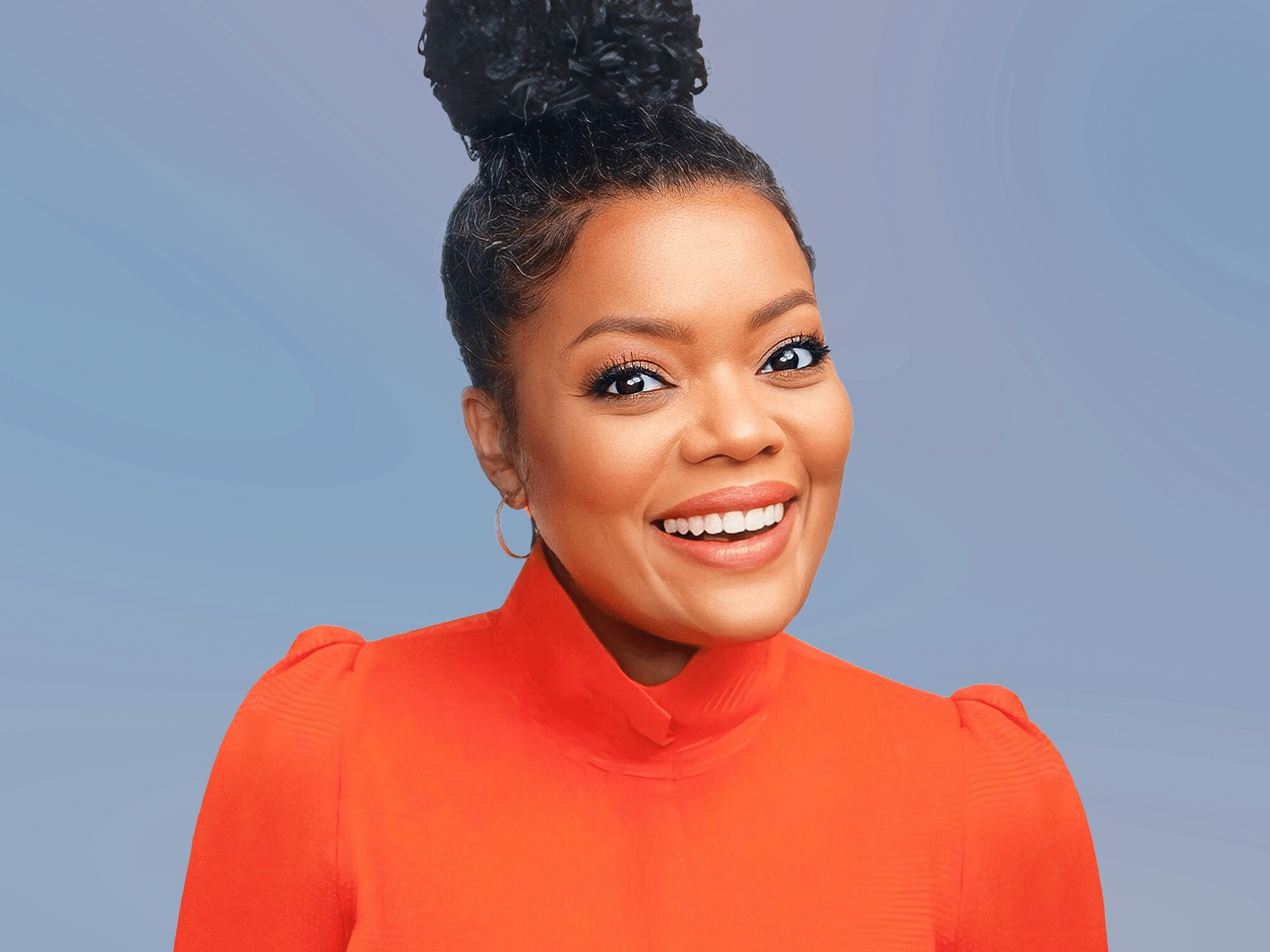 Yvette Nicole Brown wearing orange blouse